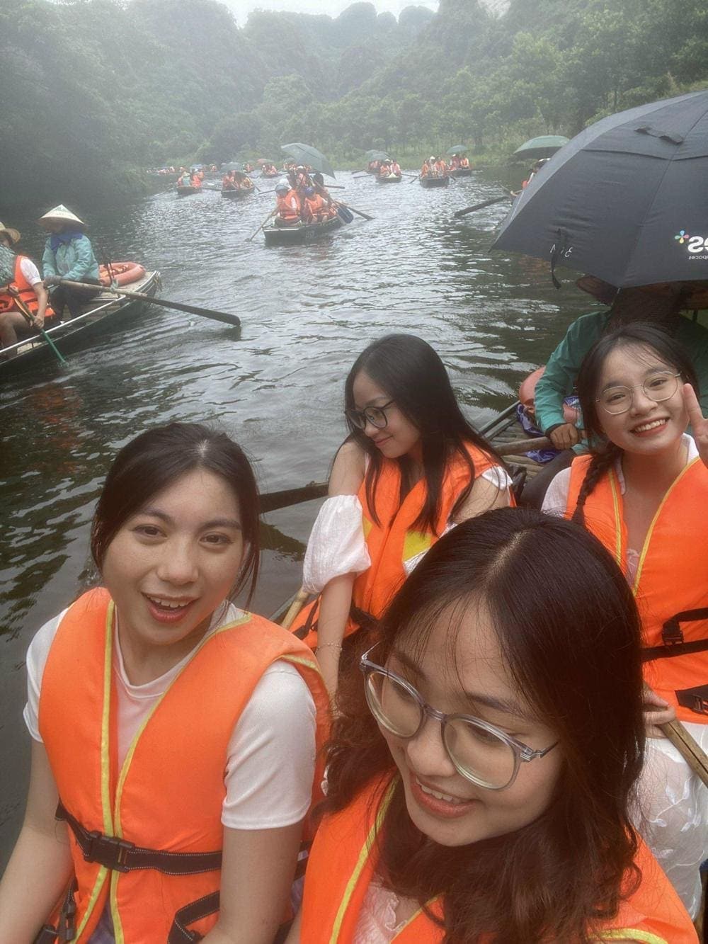 Visitors are gently rowed through vast rice paddies and beneath towering limestone caves