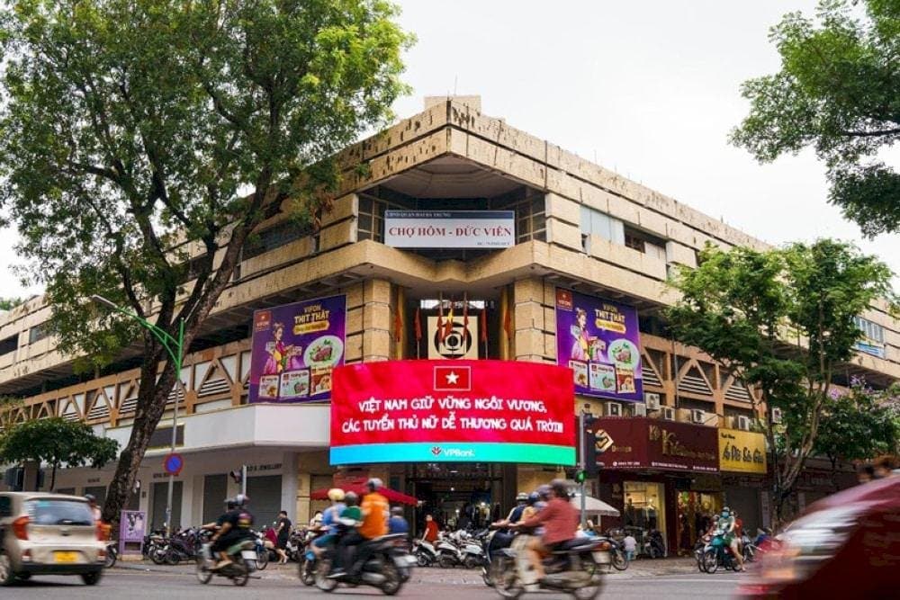Shoppers browsing through Hanoi's bustling markets, discovering local clothing, handicrafts, and fresh produce