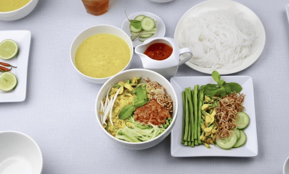 Tangy, rich broth with turmeric and herbs of Bun Num Bo Choc