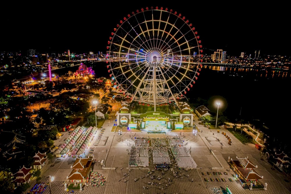 Da Nang Downtown shines at night with vibrant lights and the iconic Sun Wheel, creating a lively and colorful cityscape