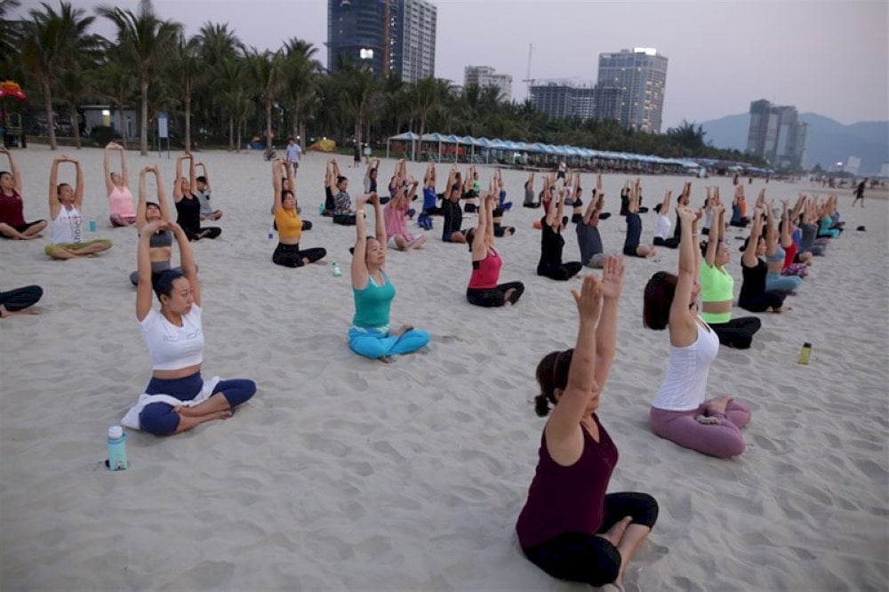 Locals gather early in the morning to engage in health-boosting activities like yoga